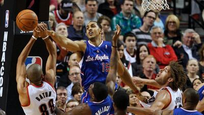 Los Angeles Clippers center Ryan Hollins, centre, blocks shot of Portland Trail Blazers forward Nicolas Batum, left, in first half action of their NBA game at the Moda Center in Portland, Oregon USA, 16 April 2014. EPA/STEVE DIPAOLA