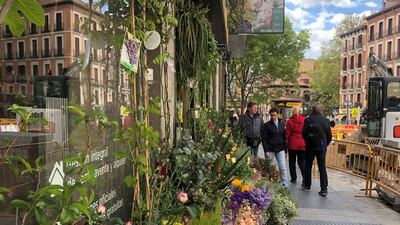 Shoppers outside a flower market in Madrid. Holly Aguirre / The National