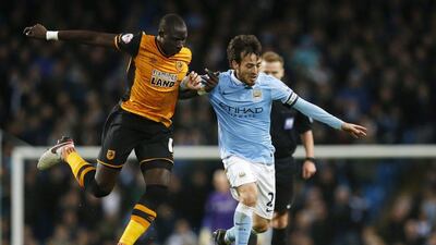 David Silva of Manchester City battles Hull City’s Mohamed Diame for the ball during their League Cup contest on Tuesday at the Etihad Stadium. Phil Noble / Reuters