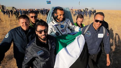 Russian space agency rescue team members and United Arab Emirates specialists carry Maj Al Mansouri. AP Photo