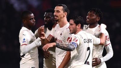 AC Milan's Zlatan Ibrahimovic celebrates with Davide Calabria and teammates after scoring against Bologna. AFP