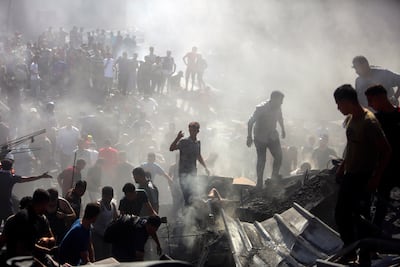 Palestinians search through the rubble of destroyed buildings after Israeli air strikes in Khan Younis. AP