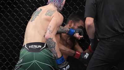 Sean O'Malley punches Raulian Paiva. Reuters