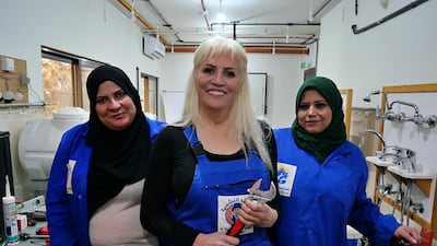 Khawla Al Sheikh, centre, the first female plumber in Jordan, with her colleagues Aisha Amayrah, left and Rehab Hamzeh. Courtesy Charlie Faulkner