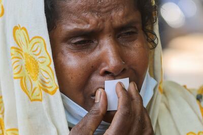 Jenima Mondal kisses a photograph of her son, crash victim Mamjur Ali Mondal, after receiving his body from the mortuary. Reuters