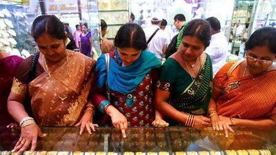 Women visiting from India, shop for jewelry at a store in Dubai. The budget has increased allowances for NRIs bringing gold into India. Gabriela Marj/Bloomberg