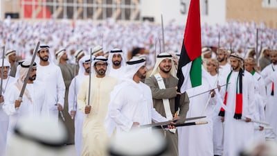Lt Gen Sheikh Saif bin Zayed, Deputy Prime Minister and Minister of Interior, performs a traditional dance during the Sheikh Zayed Heritage Festival with Sheikh Khalifa bin Tahnoun, Executive Director of the Martyrs' Families' Affairs Office and Sheikh Diab bin Tahnoon. Ryan Carter / Presidential Court