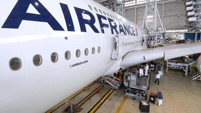 Employees work on an Airbus A380 inside the Air France KLM maintenance hangar at the Charles de Gaulle International Airport in Roissy, near Paris. Philippe Wojazer / Reuters