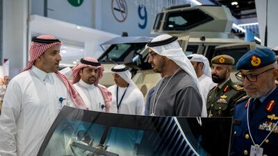 The President and Lt Gen Al Mazrouei, right, visit a booth at the event