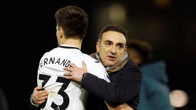 Swansea City manager Carlos Carvalhal celebrates after seeing his team beat Watford 2-1 with Federico Fernandez. Peter Nicholls / Reuters