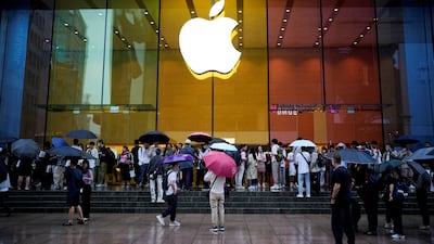 People stand outside an Apple Store in Shanghai. The company is manufacturing its own silicon to reduce its dependence on other suppliers and reduce supply chain friction. Reuters