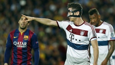 Bayern Munich striker Robert Lewandowski, wearing a protective mask, gestures during his side's Champions League match on Wednesday against Barcelona. Andreu Dalmau / EPA