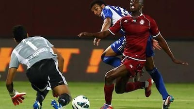 Mahmoud Darwish of Al Nasr tries to halt Al Wahda’s Marcelo Oliveira as he closes on goalkeeper Ahmed Shambieh.