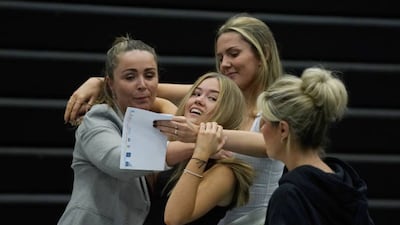 Faith Bryant and Abbie Hollis congratulate each other at Archbishop Blanch School, Liverpool.
