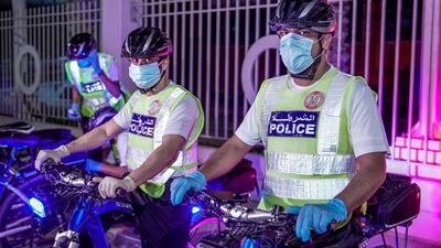 Abu Dhabi Police bicycle patrol do night operations around the Mussaffah area to warn or catch curfew violators in the residential areas. Victor Besa / The National