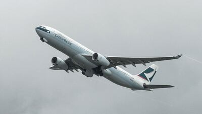 A Cathay Pacific passenger plane takes off from the international airport in Hong Kong. Cathay said first-half profit dropped 82 perc ent from a year earlier, as a Chinese economic slowdown weighs in and the airline faces increasing competition from peers. Anthony Wallace / AFP