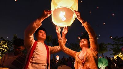 People release a sky lantern to celebrate the annual Songkran, or Thai New Year, in Jinghong in China's southwestern Yunnan province. AFP