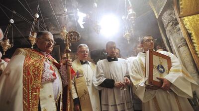 The Latin Patriarch of Jerusalem Fouad Twal leads a Christmas Midnight Mass at the Church of the Nativity in Bethlehem. Fadi Arouri / AP Photo