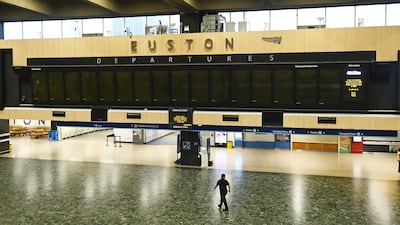 A staff member at the closed Euston Station in London. Rail services in the UK are being disrupted as 9,000 train drivers in the Aslef union strike in a row over pay and conditions. EPA