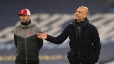 Manchester City manager Pep Guardiola, right, and Liverpool manager Jurgen Klopp. Reuters