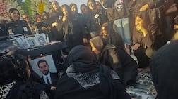 Mourners gather at a cemetery to honor protesters killed during anti-government demonstrations, in Tehran. Getty Images