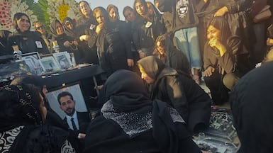 Mourners gather at a cemetery to honor protesters killed during anti-government demonstrations, in Tehran. Getty Images