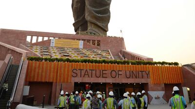 Indian construction workers are seen near the Statue Of Unity . AFP