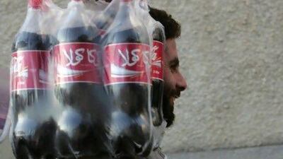 Coca-Cola is hoping its purchase of almost half of Aujan Industries will broaden its reach in a fast-growing market. Khaled Desouki / AFP