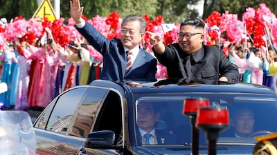 South Korean President Moon Jae-in and North Korean leader Kim Jong-un wave during a parade in Pyongyang on September 18, 2018. Pyeongyang Press Corps via Reuters