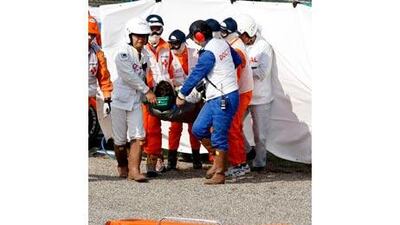 Timo Glock, the German Toyota F1 driver, is carried by rescue staff to an ambulance after crashing during qualifying for the Japanese Grand Prix in Suzuka this month.