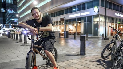 Haitham Al Bayed, 23, rides his BMX bike in the neighbourhood square. Victor Besa / The National