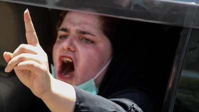 A woman shouts slogans during a protest. EPA
