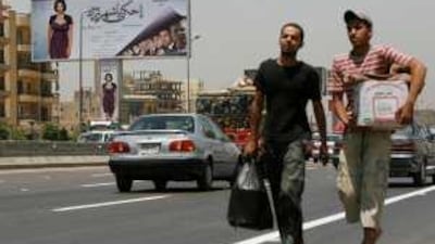 Posters featuring the actress Mona Zaki loom above a ring road in Cairo.
