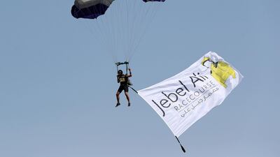 A skydiver lands in the parade ring on the opening meeting at Jebel Ali racecourse in Dubai. All photos by Chris Whiteoak / The National