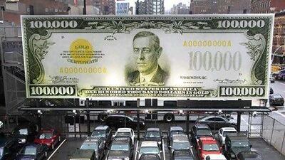 A billboard with a reproduction of a US$100,000 bill. Mark Lennihan / AP Photo
