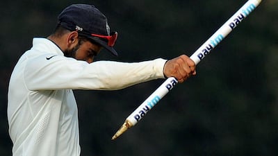 India cricket captain Virat Kohli walks with a stump after his team's victory in the fifth and final Test match between India and England at the M.A. Chidambaram Stadium in Chennai on December 20, 2016. Arun Sankar / AFP