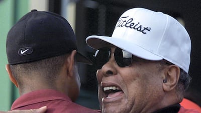 Tiger Woods is hugged by his father Earl. AFP