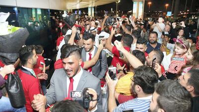 Syria’s national team are mobbed by fans as they arrive in Sharjah. All images are handouts