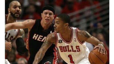 Mike Bibby, right, of Chicago, tries to find a way past the Miami defence during Game 1 of their Eastern Conference play-off final on Sunday night. The Bulls beat the Heat 103-82.