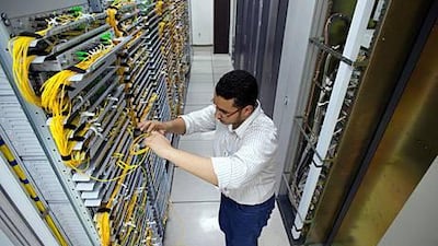 An Etisalat employee works on a company order for high speed fiber optic internet service in the basement at the headquarters of Etisalat.