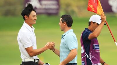 Omega Dubai Desert Classic winner Haotong Li, left, is congratulated by runner-up Rory McIlroy on his victory. Andrew Redington / Getty Images