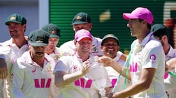 Australia's stand-in captain Steve Smith, centre, and Pat Cummins with the Ashes trophy at the Sydney Cricket Ground. PA