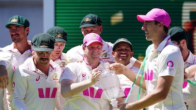 Australia's stand-in captain Steve Smith, centre, and Pat Cummins with the Ashes trophy at the Sydney Cricket Ground. PA
