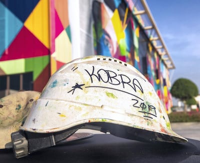 When we met him Kobra's helmet, phone and clothes were splattered in paint.