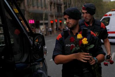 Police officers hold roses given to them by people after a march of unity. Juan Medina/ Reuters