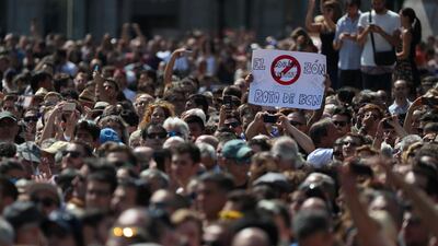 A banner is held above the crowd as people observe a minute of silence in Placa de Catalunya, a day after a van crashed into pedestrians at Las Ramblas. Sergio Perez / Reuters.