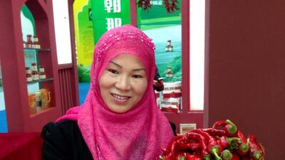 Ma Chengming holding a basket of chilies. Photo by Clifford Coonan