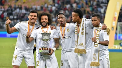Real Madrid's Brazilian players Casemiro, Marcelo, Vinicius Junior, Eder Militao and Rodrygo pose with the trophy after winning the Spanish Super Cup on January 12, 2020, in the Saudi Arabian port city of Jeddah. AFP