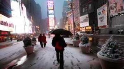 Early morning pedestrians walk in New York City's Times Square. A reader recommends Times Square as an example of pedestrian-friendly city planning.