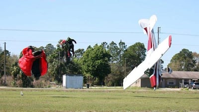 The parachutist is thrown clear as the plane nosedives into the ground. Tim Telford / AP Photo / March 8, 2014